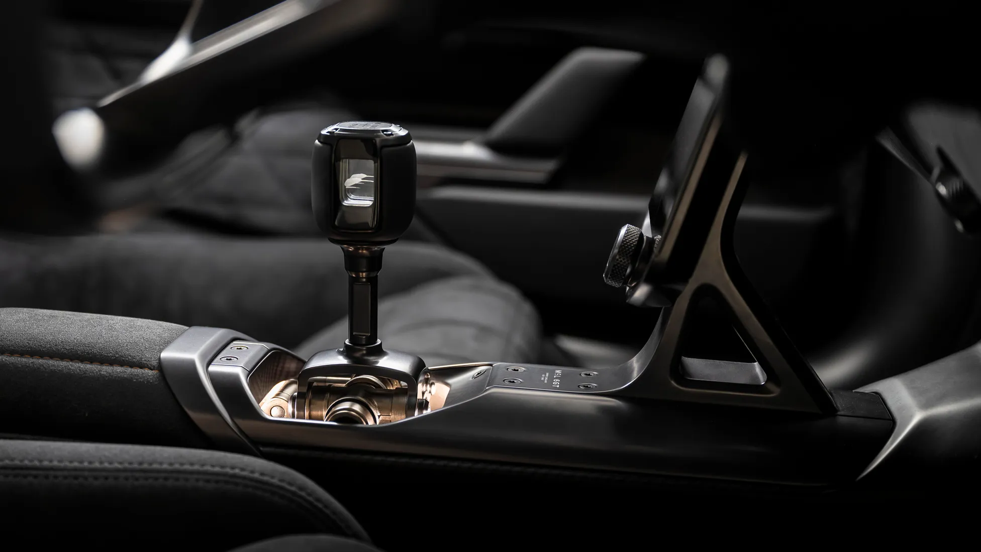 Interior detail of the McLaren McL 6GT showing the exposed brass gear linkage in the centre console