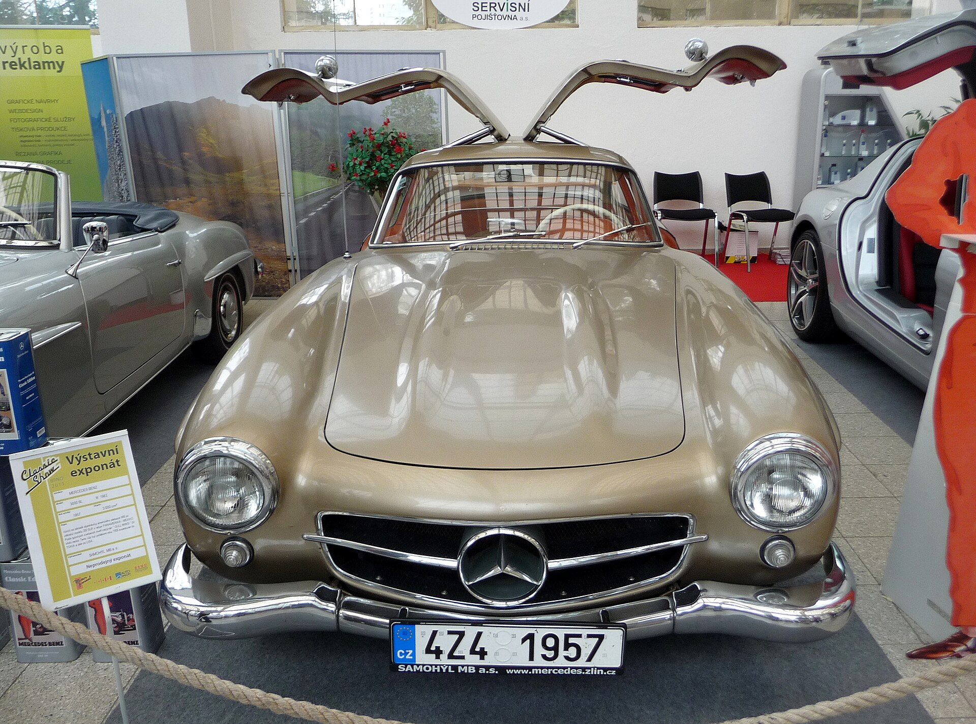 A front view of the Mercedes-Benz 300 SL with its iconic gullwing doors fully open.